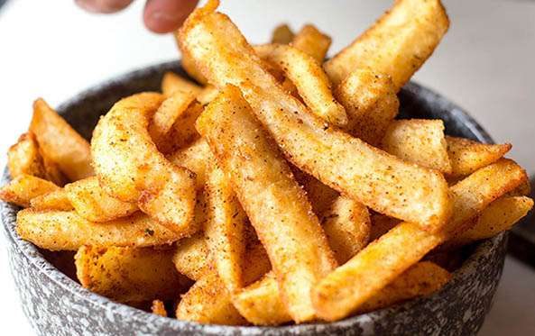 Bowl of crispy chips dusted with spicy seasoning