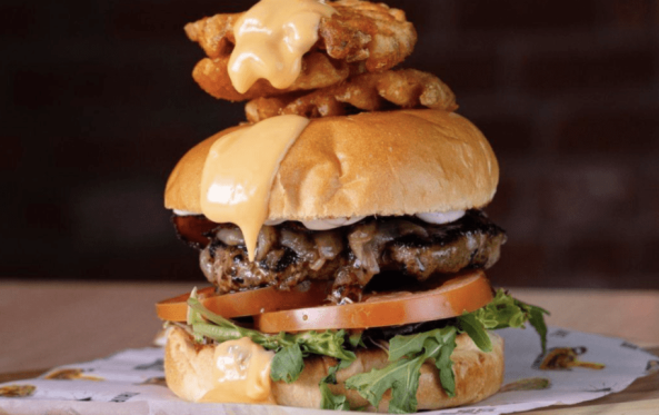 Classic burger with lettuce, tomato and a waffle fry skewer