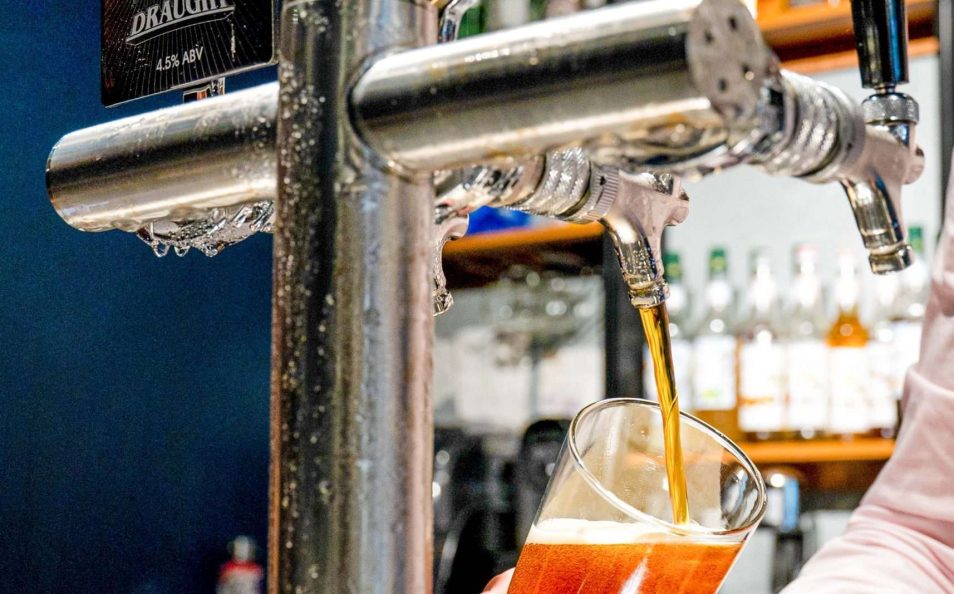 Beer being poured from a tap at the bar