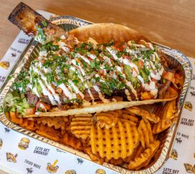 Big Beefy Taco loaded with meat and lettuce over waffle fries