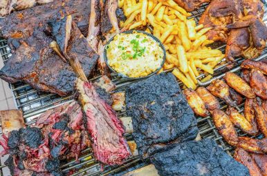 Smoked meats and ribs laid out on prep trays