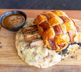 Triple Beef Rib Wellington with pastry lattice on mash, gravy on the side