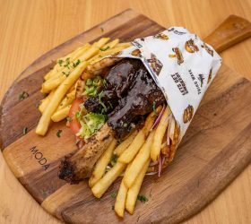 Mini Thor's Hammer Kebab wrap with fries on a wooden board