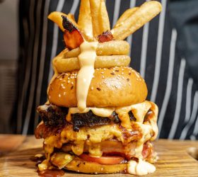 Mac Bomb On Steroids burger with bacon and waffle fries on top