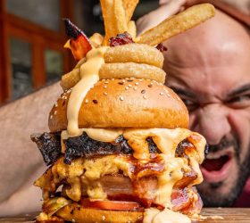 Mac Bomb On Steroids burger stacked with cheese and onion rings