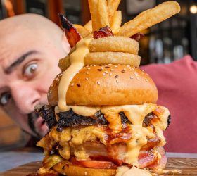 Mac Bomb on Steroids burger topped with onion rings and fries