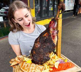 Guest holding the BBQ Lambo Platter with a whole lamb shoulder and tortillas