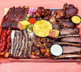 Meat Coma Platter with ribs, wings, sausages, pickles and sides