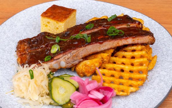 Pork ribs plate with cornbread, waffle fries and sauerkraut