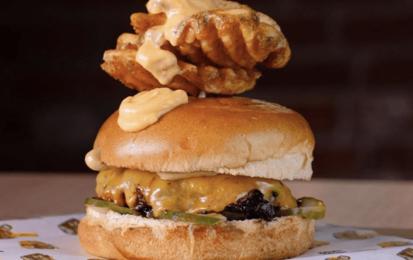 Naked burger with melted cheese and a waffle fry skewer