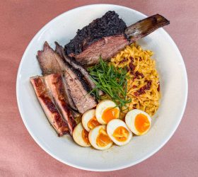 Bowl of Meat Overloaded Carbonara Ramen topped with brisket and egg