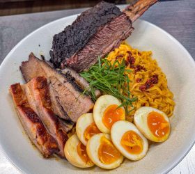 Meat Overloaded Carbonara Ramen with sliced brisket and soft-boiled egg