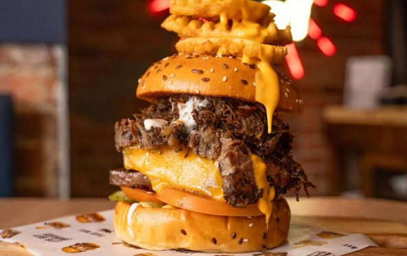 Oh Papi burger stacked high with a waffle fry skewer