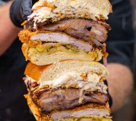 The Hog Father stacked burger with crumbed pork, slaw and pickle