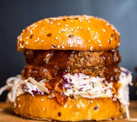 Pulled Pork Burger with coleslaw and barbecue sauce on a sesame bun
