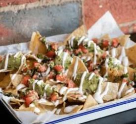 Loaded nachos with tomato salsa, guacamole and sour cream