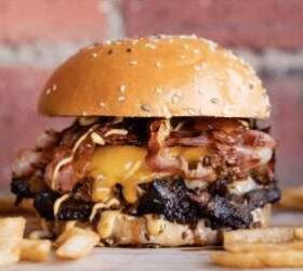 Burger stacked with brisket, cheese and bacon on a sesame bun