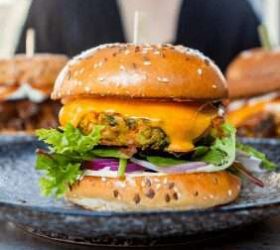 Beef burger with cheese, lettuce and red onion on a sesame bun