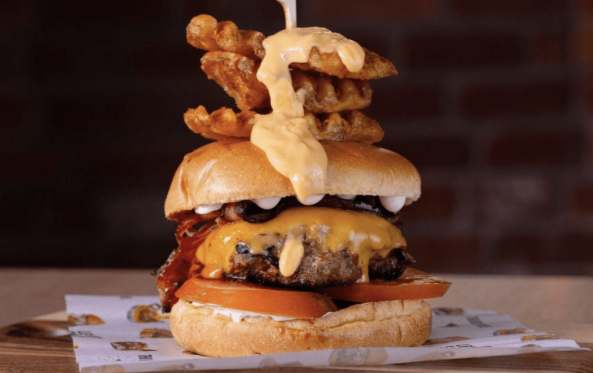 Royal burger with bacon, cheese and a waffle fry skewer