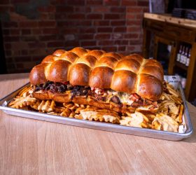 Giant slider slab tray showing pulled meat filling
