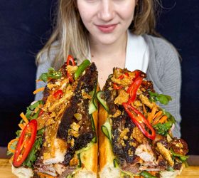 Guest with the Monster BBQ Banh Mi filled with brisket, herbs and chilli