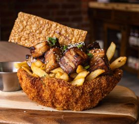 Teriyaki pork katsu bowl with crispy fries and a rice cracker