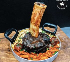 Thor's Hammer beef shin smoking in a pan with fries and slaw