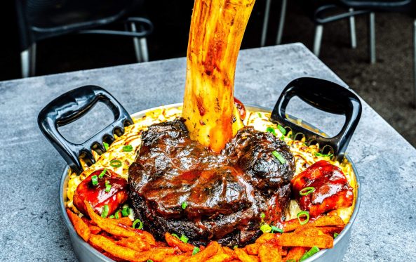 Thor's Hammer smoked beef shin with sauce poured over loaded fries