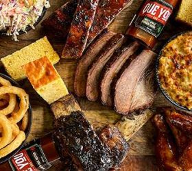 Overhead spread of brisket, ribs, onion rings and cornbread