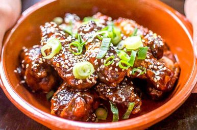 Slow-smoked chicken wings glazed with sesame and spring onion