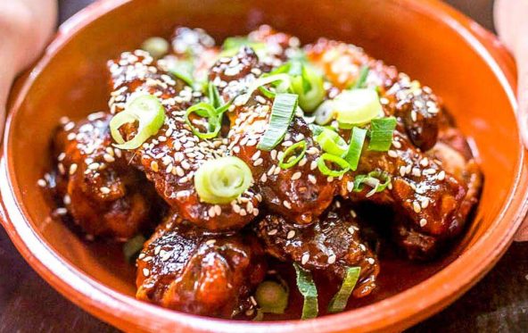 Slow-smoked chicken wings glazed with sesame and spring onion