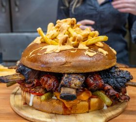 Almighty Burger loaded with brisket, bacon and a stack of fries on top