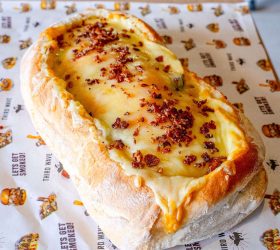 BBQ boat bread roll filled with melted cheese and bacon