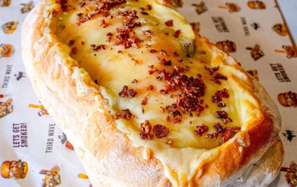 BBQ boat bread roll filled with melted cheese and bacon