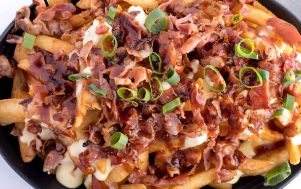 Loaded fries with bacon, cheese sauce and spring onion
