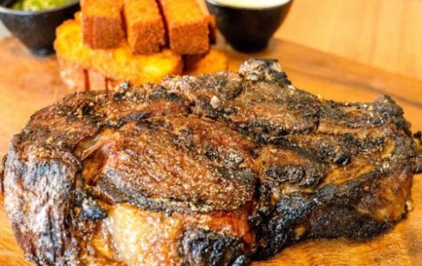 Grilled steak served with dipping sauces and crispy chips