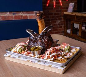 Thor's Hammer Nachos with a beef shin bone and dipping sauces