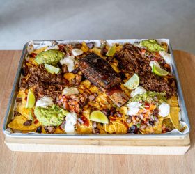 Triple Beef Nachos topped with guacamole, sour cream and jalapenos